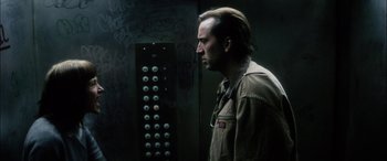 Movie still from “Bringing Out the Dead” (1999), directed by Martin Scorsese – A man standing in front of an electrical box; Close Up shot, Low angle