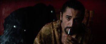 Movie still from “Bringing Out the Dead” (1999), directed by Martin Scorsese – A person holding a cigarette in his mouth; Close Up shot, Over the shoulder angle