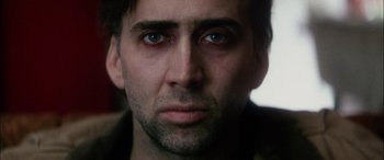 Movie still from “Bringing Out the Dead” (1999), directed by Martin Scorsese – A man's face with blue eyes; Close Up shot, Overhead angle