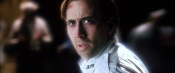 Movie still from “Bringing Out the Dead” (1999), directed by Martin Scorsese – A man in a white shirt is looking at the camera; Close Up shot, Low angle