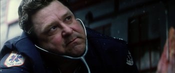 Movie still from “Bringing Out the Dead” (1999), directed by Martin Scorsese – A person wearing headphones; Close Up shot, Low angle