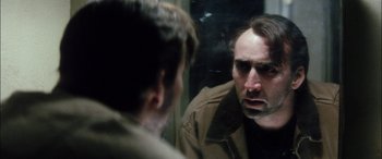 Movie still from “Bringing Out the Dead” (1999), directed by Martin Scorsese – A man looking at himself in the mirror; Close Up shot, Over the shoulder angle