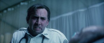 Movie still from “Bringing Out the Dead” (1999), directed by Martin Scorsese – A man in a white shirt is looking at the camera; Close Up shot, Low angle