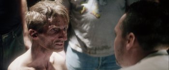 Movie still from “Bringing Out the Dead” (1999), directed by Martin Scorsese – A man is looking at another man in the background; Close Up shot, Over the shoulder angle