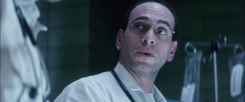Movie still from “Bringing Out the Dead” (1999), directed by Martin Scorsese – A person wearing glasses and a white shirt; Close Up shot, Low angle