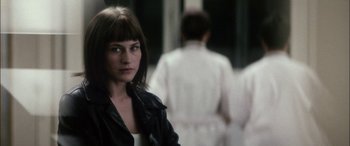 Movie still from “Bringing Out the Dead” (1999), directed by Martin Scorsese – A woman in a leather jacket standing in front of two other women; Close Up shot, Over the shoulder angle