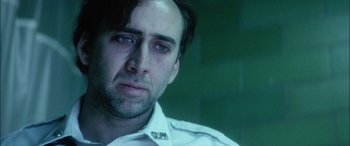 Movie still from “Bringing Out the Dead” (1999), directed by Martin Scorsese – A man in a white shirt is looking at the camera; Close Up shot, Low angle