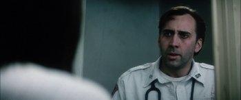 Movie still from “Bringing Out the Dead” (1999), directed by Martin Scorsese – A man with a stethoscope around his neck looking into a mirror; Close Up shot, Over the shoulder angle