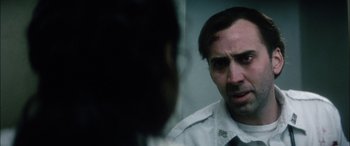 Movie still from “Bringing Out the Dead” (1999), directed by Martin Scorsese – A person looking at another person; Close Up shot, Over the shoulder angle