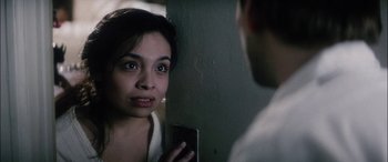 Movie still from “Bringing Out the Dead” (1999), directed by Martin Scorsese – A woman looking at a man with a cell phone in front of her face; Close Up shot, Over the shoulder angle