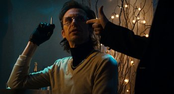 Movie still from “Bronson” (2008), directed by Nicolas Winding Refn – A man with glasses is pointing to his head; Close Up shot, Low angle