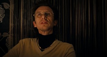 Movie still from “Bronson” (2008), directed by Nicolas Winding Refn – A man wearing glasses and wearing a sweater; Close Up shot, Low angle