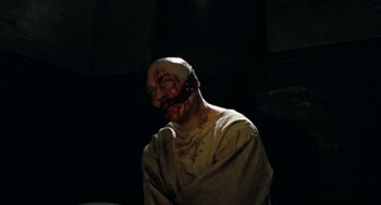 Movie still from “Bronson” (2008), directed by Nicolas Winding Refn – A man with a face covered in blood and makeup; Close Up shot, High angle