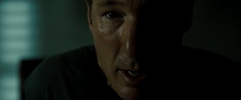 Movie still from “Brooklyn's Finest” (2009), directed by Antoine Fuqua – A man's face in the dark; Close Up shot, Over the shoulder angle