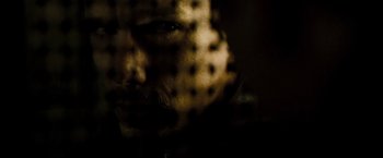 Movie still from “Brooklyn's Finest” (2009), directed by Antoine Fuqua – A person's face behind a screen; Extreme Close Up shot, Over the shoulder angle