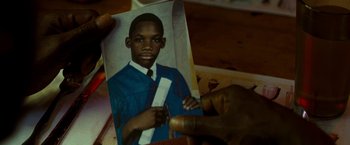 Movie still from “Brooklyn's Finest” (2009), directed by Antoine Fuqua – A person holding a picture of a young man; Extreme Close Up shot, High angle