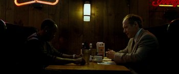 Movie still from “Brooklyn's Finest” (2009), directed by Antoine Fuqua – Two people sitting at a table with a cup of coffee; Medium shot, Over the shoulder angle