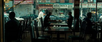 Movie still from “Brooklyn's Finest” (2009), directed by Antoine Fuqua – Two police officers sitting at a table in front of a restaurant; Wide shot, Over the shoulder angle