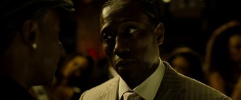 Movie still from “Brooklyn's Finest” (2009), directed by Antoine Fuqua – A person wearing a suit and tie; Close Up shot, Over the shoulder angle