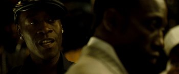 Movie still from “Brooklyn's Finest” (2009), directed by Antoine Fuqua – A man wearing a hat is looking at another man; Close Up shot, Over the shoulder angle