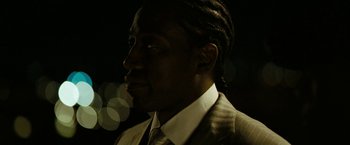 Movie still from “Brooklyn's Finest” (2009), directed by Antoine Fuqua – A person wearing a suit and tie; Close Up shot, Over the shoulder angle