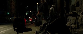 Movie still from “Brooklyn's Finest” (2009), directed by Antoine Fuqua – A man walking down the stairs of a building at night; Wide shot, High angle