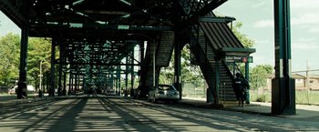 Movie still from “Brooklyn's Finest” (2009), directed by Antoine Fuqua – Cars parked on the side of a road under a bridge; Extreme Wide shot, Low angle
