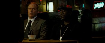 Movie still from “Brooklyn's Finest” (2009), directed by Antoine Fuqua – Two men sitting at a table in a restaurant; Medium shot, Over the shoulder angle