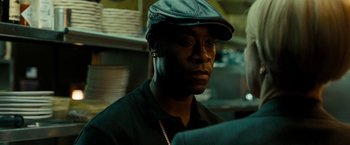 Movie still from “Brooklyn's Finest” (2009), directed by Antoine Fuqua – A man wearing a black hat and a black shirt; Close Up shot, Over the shoulder angle