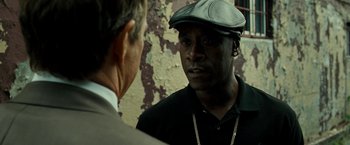 Movie still from “Brooklyn's Finest” (2009), directed by Antoine Fuqua – A man wearing a hat talking to another man in a suit; Close Up shot, Over the shoulder angle