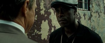Movie still from “Brooklyn's Finest” (2009), directed by Antoine Fuqua – A man wearing a black hat and a black shirt; Close Up shot, Over the shoulder angle