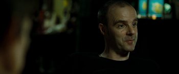 Movie still from “Brooklyn's Finest” (2009), directed by Antoine Fuqua – A person wearing a black t - shirt; Close Up shot, Over the shoulder angle