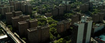 Movie still from “Brooklyn's Finest” (2009), directed by Antoine Fuqua – An aerial view of a city with many buildings and trees; Extreme Wide shot, High angle
