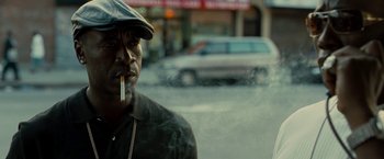 Movie still from “Brooklyn's Finest” (2009), directed by Antoine Fuqua – A man smoking a cigarette on the side of the street; Close Up shot, Low angle