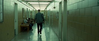 Movie still from “Brooklyn's Finest” (2009), directed by Antoine Fuqua – A man walking down a hallway in a building; Wide shot, High angle