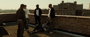 Movie still from “Brooklyn's Finest” (2009), directed by Antoine Fuqua – A group of men standing on top of a building; Wide shot, Low angle