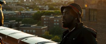 Movie still from “Brooklyn's Finest” (2009), directed by Antoine Fuqua – A man with a hat on looking out over a city; Close Up shot, Low angle