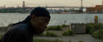 Movie still from “Brooklyn's Finest” (2009), directed by Antoine Fuqua – A person wearing a headscarf near a body of water; Close Up shot, Over the shoulder angle