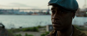 Movie still from “Brooklyn's Finest” (2009), directed by Antoine Fuqua – A person wearing a hat near a body of water; Close Up shot, Over the shoulder angle