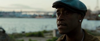 Movie still from “Brooklyn's Finest” (2009), directed by Antoine Fuqua – A person wearing a hat near a body of water; Close Up shot, Over the shoulder angle