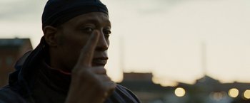 Movie still from “Brooklyn's Finest” (2009), directed by Antoine Fuqua – A person holding a finger up to their eye; Close Up shot, Over the shoulder angle