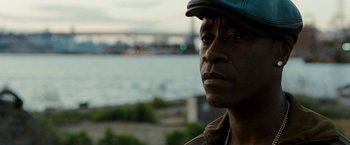 Movie still from “Brooklyn's Finest” (2009), directed by Antoine Fuqua – A person wearing a hat near a body of water; Close Up shot, Over the shoulder angle