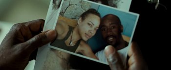 Movie still from “Brooklyn's Finest” (2009), directed by Antoine Fuqua – A man holding a picture of a woman; Extreme Close Up shot, Overhead angle