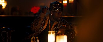 Movie still from “Brooklyn's Finest” (2009), directed by Antoine Fuqua – A man with a hat on and a candle in the background; Close Up shot, Over the shoulder angle