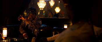 Movie still from “Brooklyn's Finest” (2009), directed by Antoine Fuqua – A man sitting on a leather couch in a room; Medium shot, Over the shoulder angle