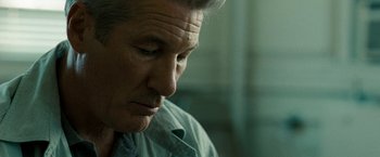 Movie still from “Brooklyn's Finest” (2009), directed by Antoine Fuqua – An older man is looking down at his face; Close Up shot, Over the shoulder angle