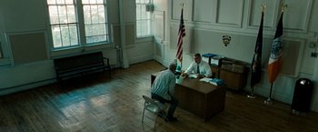 Movie still from “Brooklyn's Finest” (2009), directed by Antoine Fuqua – Two men sitting at a desk in a room; Wide shot, High angle