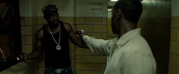 Movie still from “Brooklyn's Finest” (2009), directed by Antoine Fuqua – A man holding a gun up to another man's face; Medium shot, Over the shoulder angle