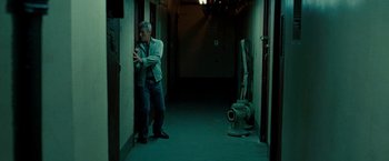 Movie still from “Brooklyn's Finest” (2009), directed by Antoine Fuqua – A man leaning against a wall in a dark room; Medium shot, Low angle