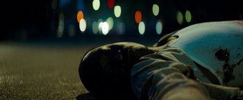 Movie still from “Brooklyn's Finest” (2009), directed by Antoine Fuqua – A man laying on the ground with his eyes closed; Extreme Close Up shot, Overhead angle